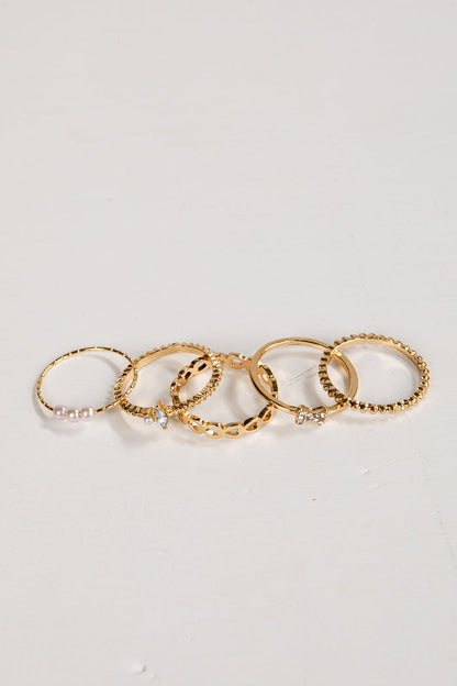 Set of gold rings on a light gray background