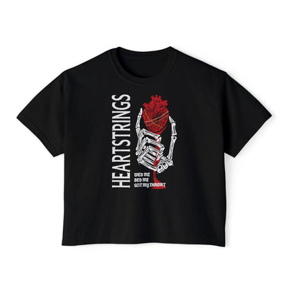 Black cropped Comfort Colors t-shirt from thtgrlreads Liv Zander collection featuring a graphic of a skeletal hand holding an anatomical heart with the vertical text "HEARTSTRINGS" and smaller text "wed me bed me slit my throat" in bold style.
