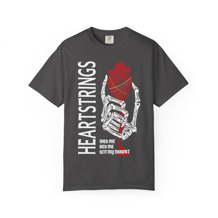 Thtgrlreads Liv Zander collection Comfort Colors vintage wash graphic tee featuring a skeletal hand holding a red anatomical heart with "HEARTSTRINGS" text and a stylized quote in bold print.