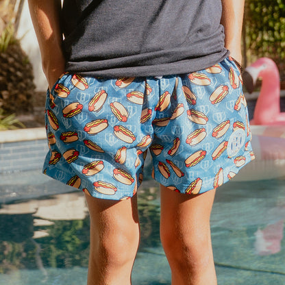 Youth model wearing youth shorts with "Hot Dog" design