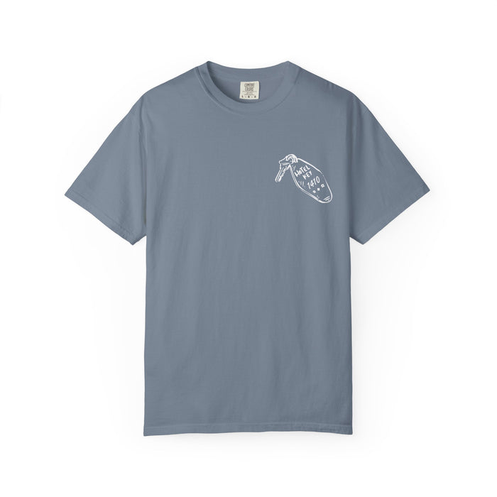 A vintage wash Comfort Colors graphic tee in muted blue with a small white line art design on the chest, part of thtgrlreads' Hockey Romance and Tees collections.