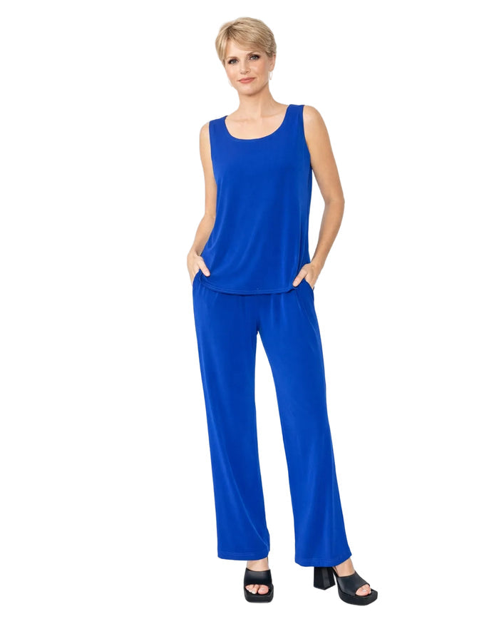 Woman wearing a royal blue matching 
sleeveless top and pants on a white background