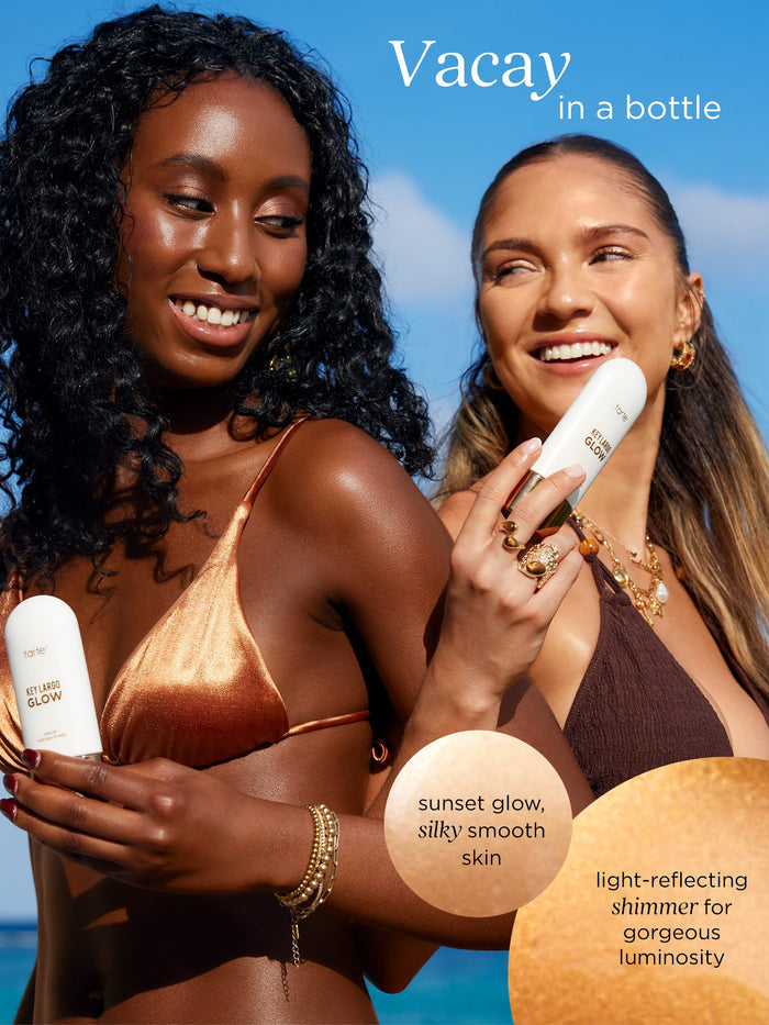 Two women holding sunscreen bottles with a blue sky background