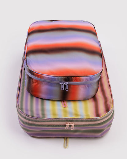 Large packing cubes with gradient stripe pattern and zippered compartments, metallic look