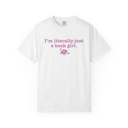Thtgrlreads officially licensed comfort colors graphic tee from the Book Bestie collection featuring vintage washed white fabric and pink text reading "I'm literally just a book girl" with a small book graphic.