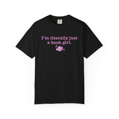 Black Comfort Colors graphic tee from thtgrlreads featuring vintage-wash cotton with a pink printed design that reads "I'm literally just a book girl" and a small heart-adorned book graphic, part of the Book Bestie and Tees collections.