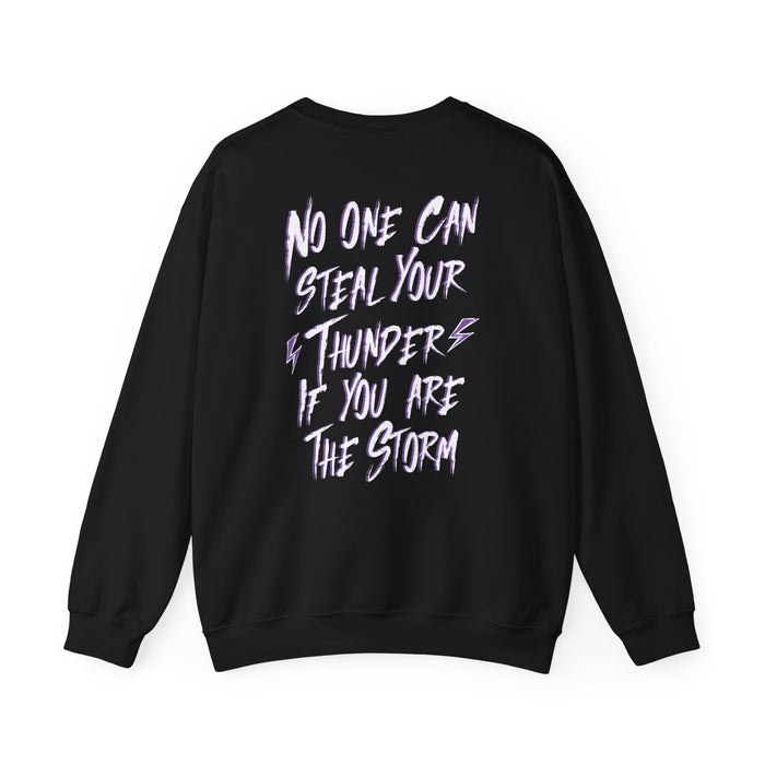 Thtgrlreads Lady of Darkness & Legacy Series oversized crewneck sweatshirt in black with bold white and purple graphic text reading "No one can steal your thunder if you are the storm" on the back, featuring a vintage-washed Comfort Colors base.