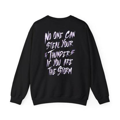 Thtgrlreads Lady of Darkness & Legacy Series oversized crewneck sweatshirt in black with bold white and purple graphic text reading "No one can steal your thunder if you are the storm" on the back, featuring a vintage-washed Comfort Colors base.