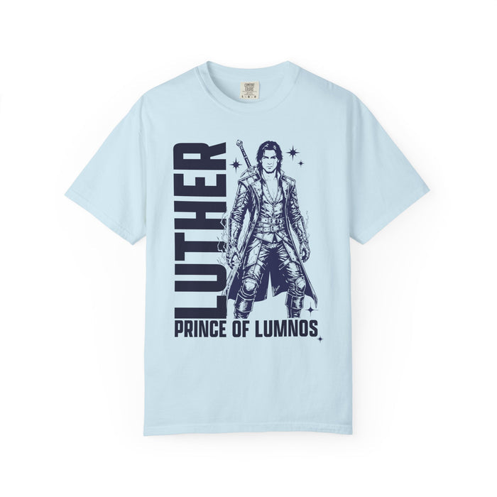 Kindred's Curse Saga tee by thtgrlreads featuring a vintage wash Comfort Colors graphic tee in light blue with bold black print of a fantasy character and text "Luther Prince of Lumnos," part of official licensed bookish apparel collections.