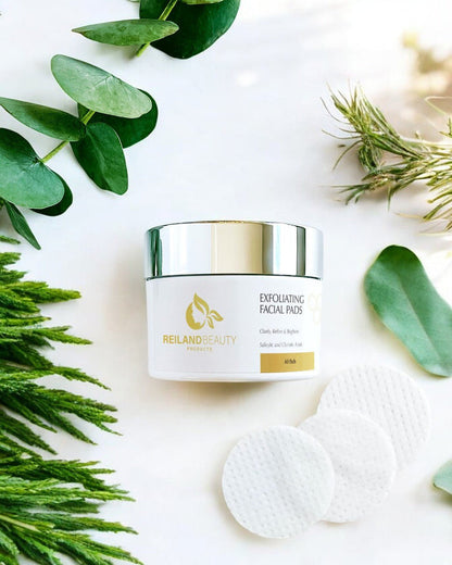 Jar of Reiland Exfoliating Facial Pads placed on white background with green botanical leaves, emphasizing natural ingredients and luxury skincare appeal.