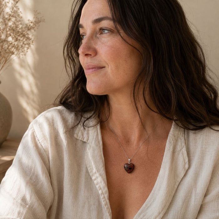 Woman wearing a Mahogany Obsidian heart pendant