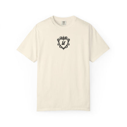 Liv Zander collection Comfort Colors graphic tee from thtgrlreads featuring a vintage wash cream fabric and a black ornate heart with the letter M printed on the chest.