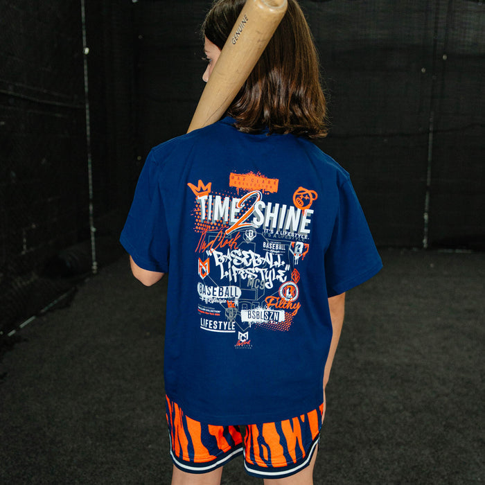Youth model wearing orange Max Clark Tiger Court youth shorts