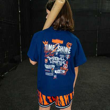 Youth model wearing orange Max Clark Tiger Court youth shorts