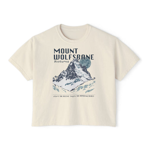 thtgrlreads Wolves of Ruin collection crop top featuring a vintage-wash Comfort Colors fabric with a graphic print of a snowy mountain scene and bold "Mount Wolfsbane" text.