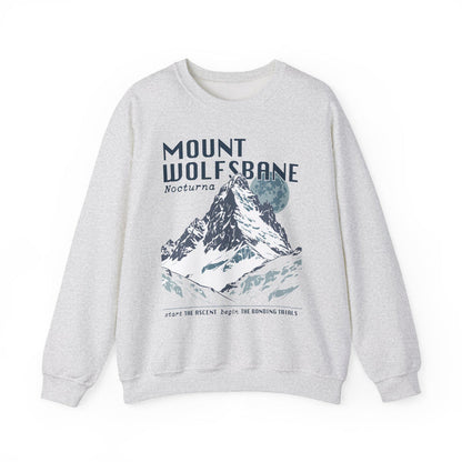 Thtgrlreads Wolves of Ruin collection vintage-wash Comfort Colors crewneck sweatshirt featuring a bold Mount Wolfsbane mountain graphic with moonlit night theme and stylized text.