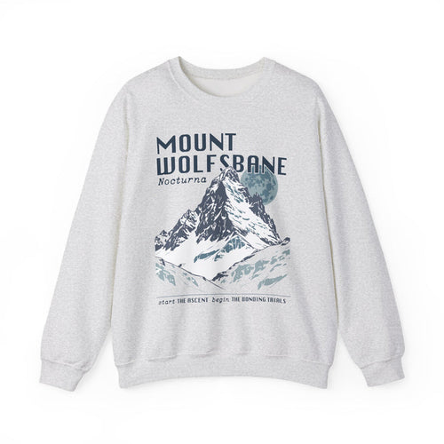 Thtgrlreads Wolves of Ruin collection vintage-wash Comfort Colors crewneck sweatshirt featuring a bold Mount Wolfsbane mountain graphic with moonlit night theme and stylized text.