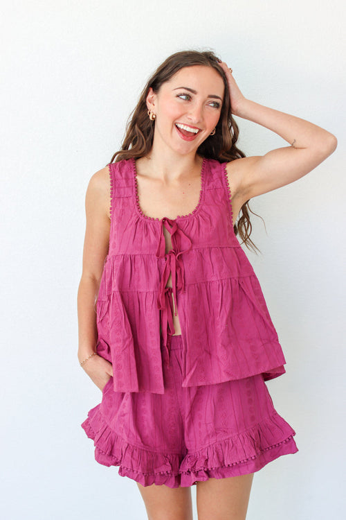 Woman wearing a purple outfit set against a white background
