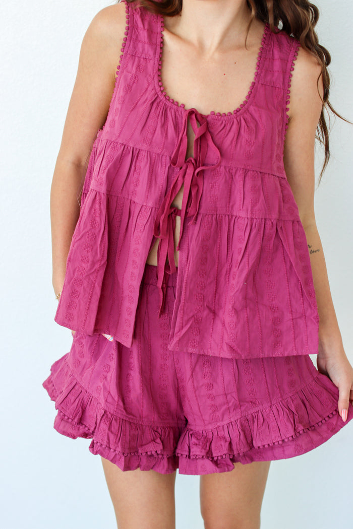 Woman wearing a purple outfit set against a white background