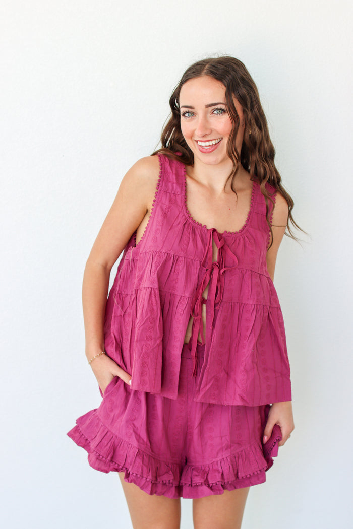 Woman wearing a purple outfit set against a white background