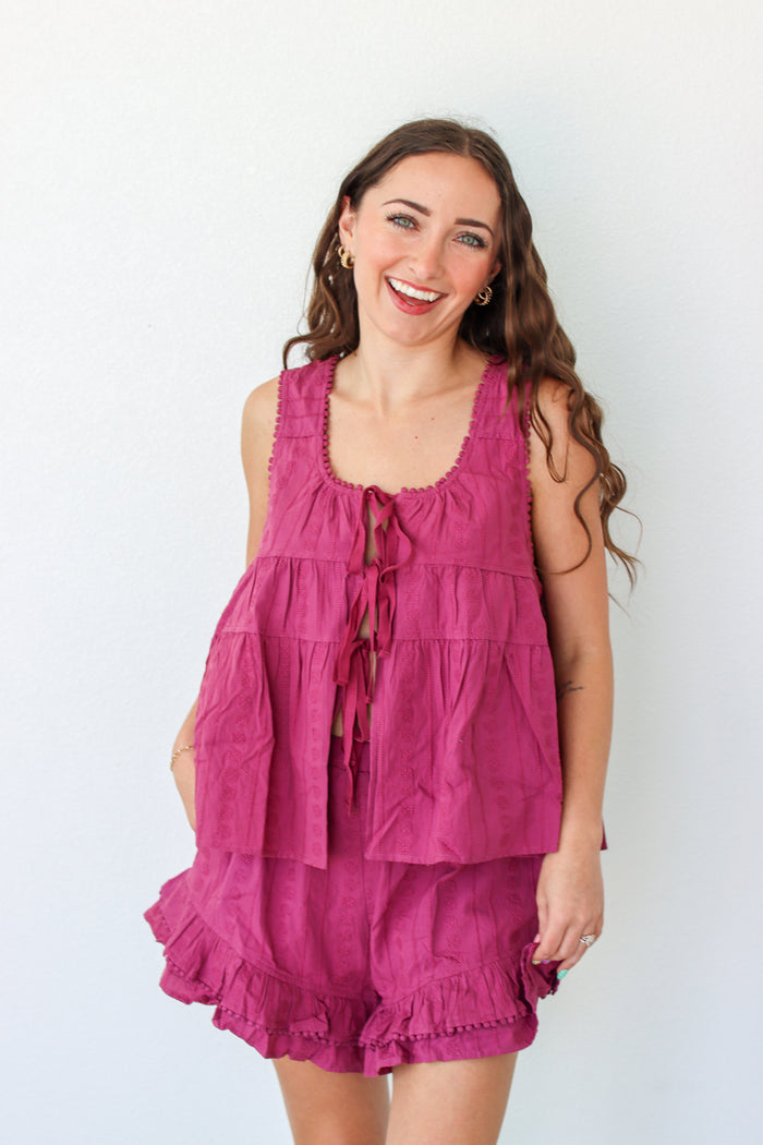Woman wearing a purple outfit set against a white background