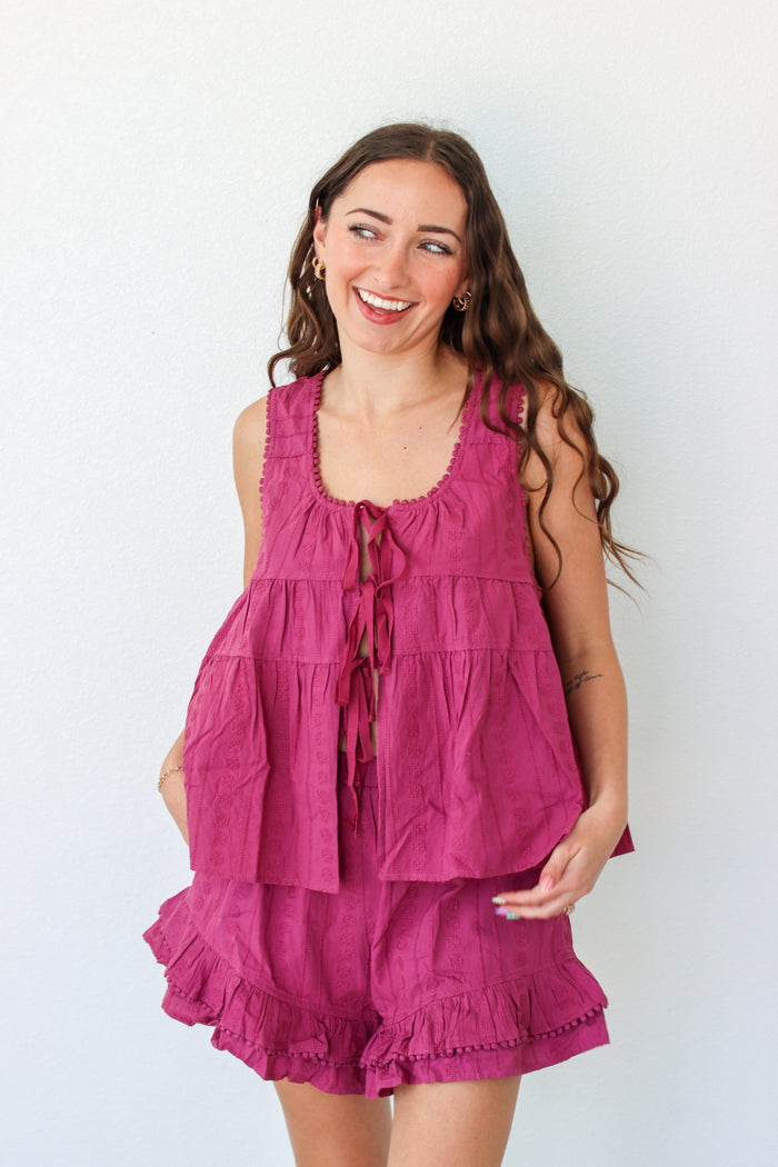 Woman wearing a purple outfit set against a white background