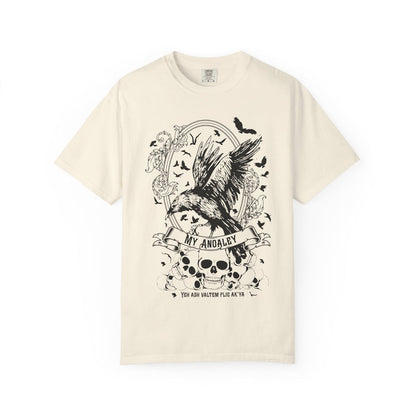 A vintage-wash comfort colors graphic tee from thtgrlreads featuring Liv Zander-inspired fantasy artwork with a detailed black crow, skulls, and gothic script, part of the Liv Zander and Tees collections.