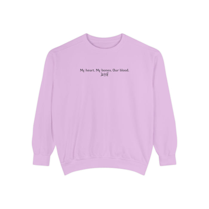 Officially licensed The Poison Daughter crewneck from thtgrlreads featuring a vintage-washed lavender Comfort Colors oversized sweatshirt with black gothic script text reading "My heart. My bones. Our blood.