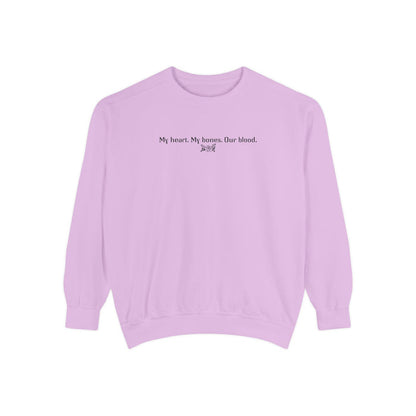 Officially licensed The Poison Daughter crewneck from thtgrlreads featuring a vintage-washed lavender Comfort Colors oversized sweatshirt with black gothic script text reading "My heart. My bones. Our blood.