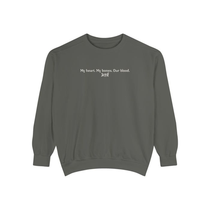 The Poison Daughter collection cozy crewneck sweatshirt by thtgrlreads in vintage-washed comfort colors fabric, featuring white minimalist text "My heart. My bones. Our blood." across the chest.