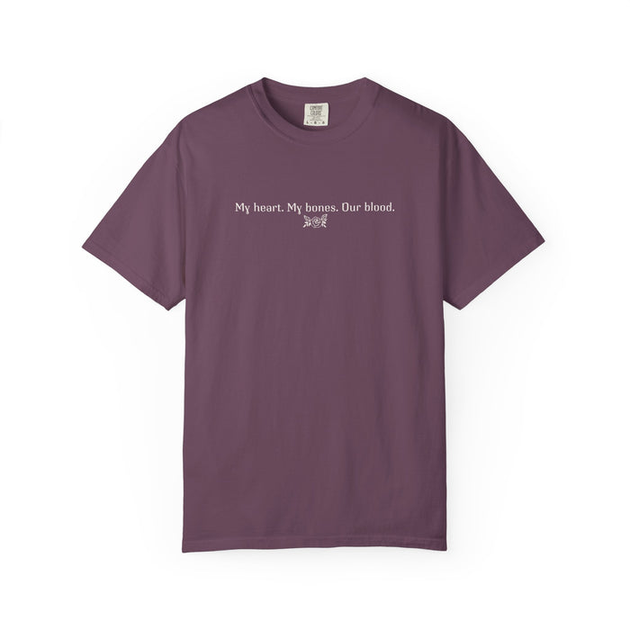 A vintage wash Comfort Colors graphic tee from thtgrlreads featuring a simple white text print reading "My heart. My bones. Our blood." inspired by The Poison Daughter collection.
