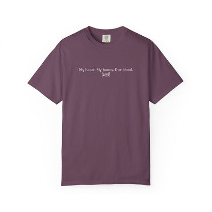 A vintage wash Comfort Colors graphic tee from thtgrlreads featuring a simple white text print reading "My heart. My bones. Our blood." inspired by The Poison Daughter collection.