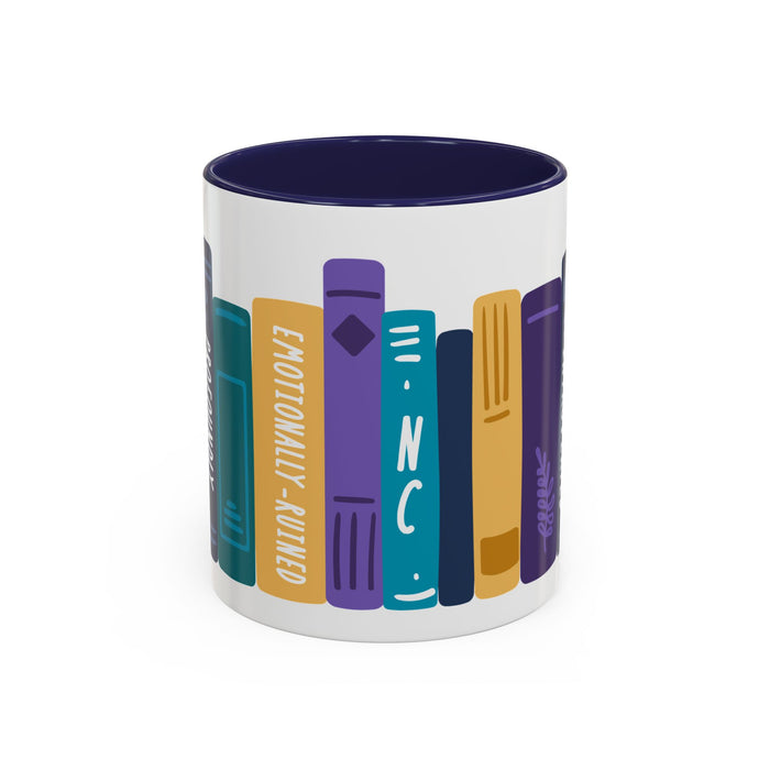 Ceramic mug from thtgrlreads featuring colorful vertical book spines with titles including "Emotionally-Ruined" and "NC" in a playful, graphic design on a white base with a dark blue interior.
