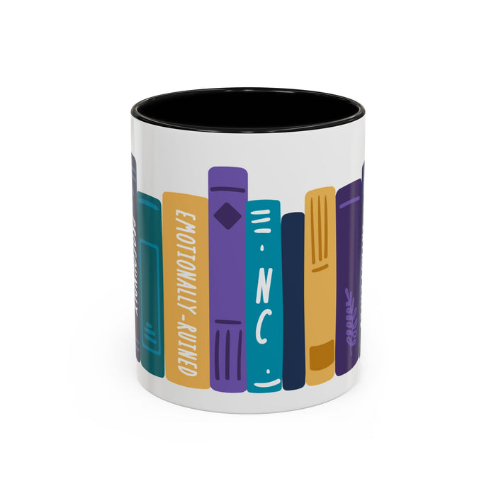 White ceramic mug with black interior featuring colorful, stylized book spines including one labeled "Emotionally Ruined" in a playful design by thtgrlreads.