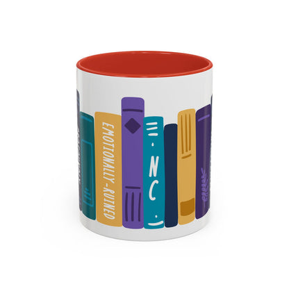 White ceramic mug from thtgrlreads featuring a colorful book spine design with titles like "Emotionally Ruined" and "NC," accented by a vibrant red interior.