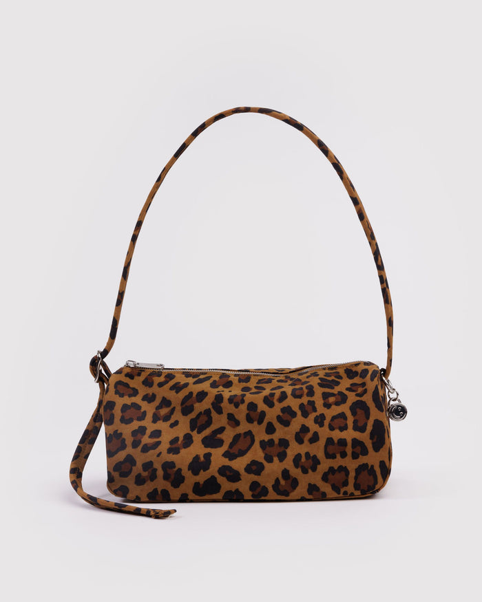 Leopard print nylon loaf bag with curved top handle, side strap, and top zipper.