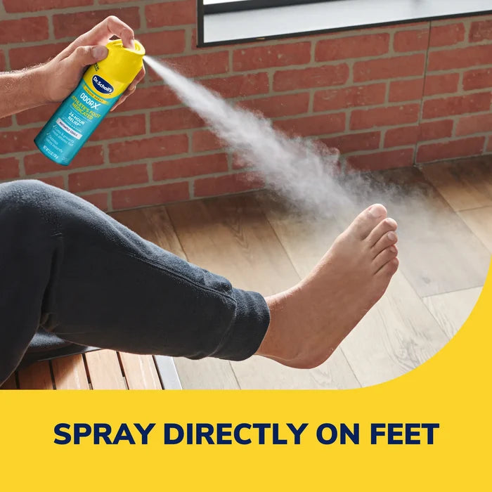 Athlete's foot medicated liquid spray bottle spraying mist onto bare foot.