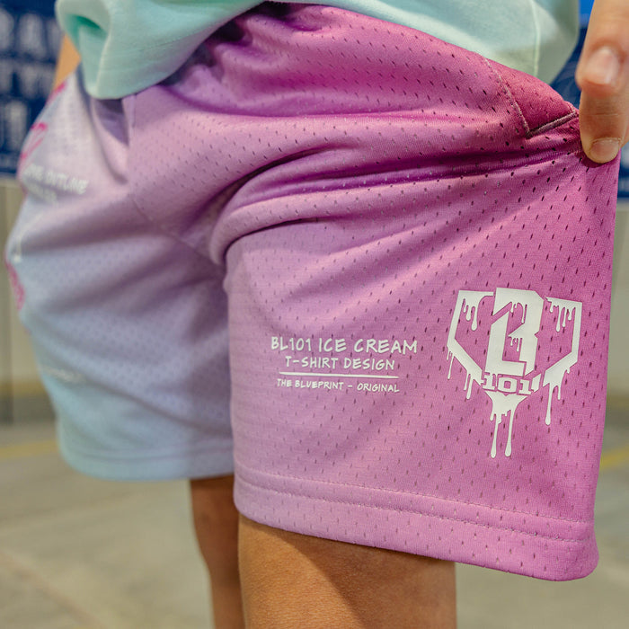 Pink and blue shorts with a BL101 logo and 'BL101 Ice Cream T-Shirt design text on a person wearing a light green shirt