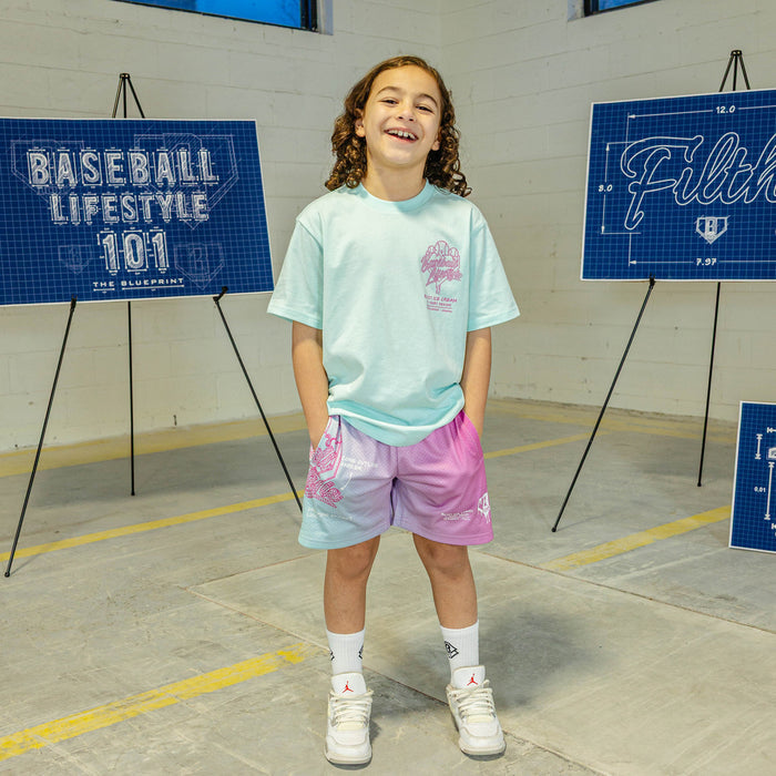 Pink-blue shorts with a BL101 logo and text on a person wearing a light green shirt.