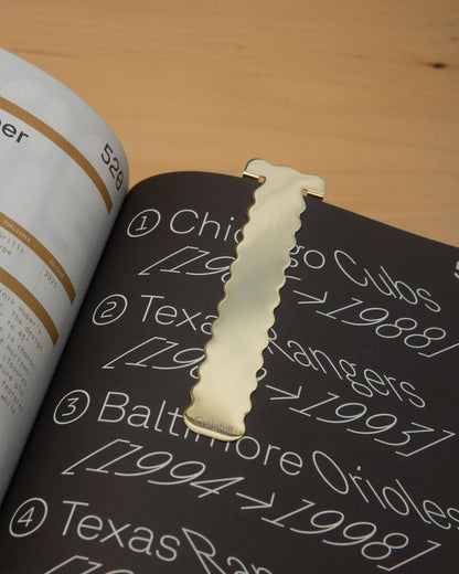Brass perch-shaped bookmark
