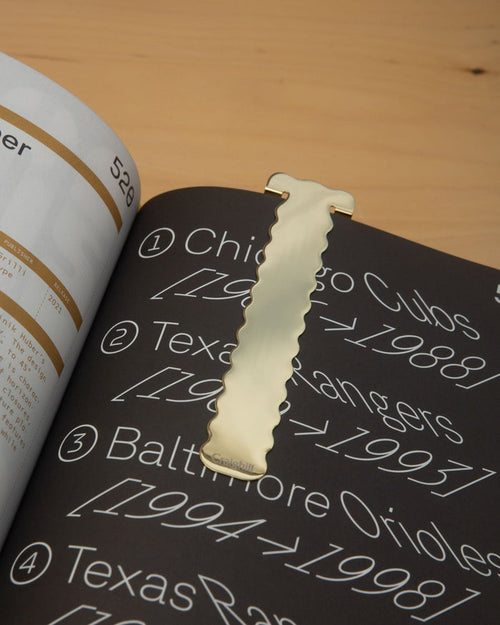 Brass perch-shaped bookmark