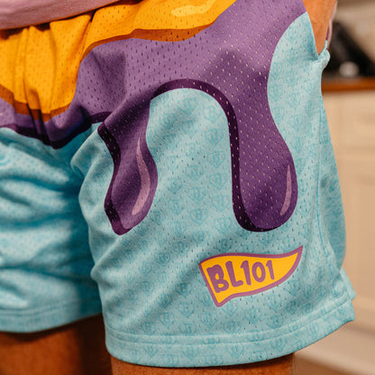 Detail close-up of the dripping purple jelly graphic and BL101 pennant logo on the light blue mesh shorts.