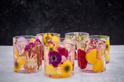 Landscape photo of a pressed flower round resin ring holder with mixed dried botanical layers