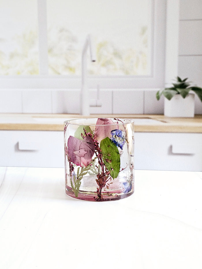 Tall portrait photo of a pressed flower large ring holder with soft dried flowers in clear resin