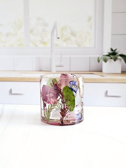 Tall portrait photo of a pressed flower large ring holder with soft dried flowers in clear resin
