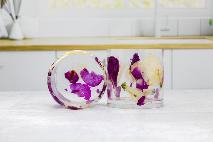 Landscape photo of a pressed flower whiskey cup with mixed dried blooms in clear resin