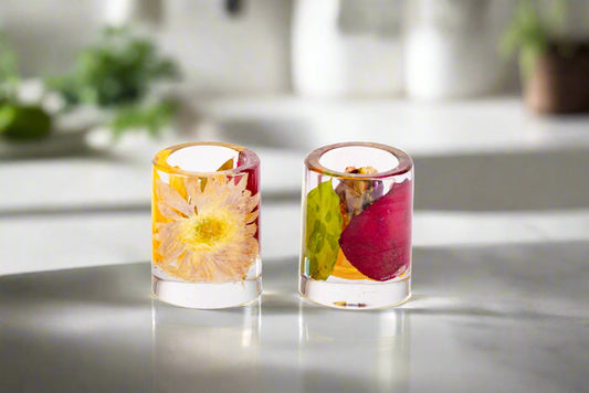 Set of 2 pressed flower resin shot glasses on a kitchen counter