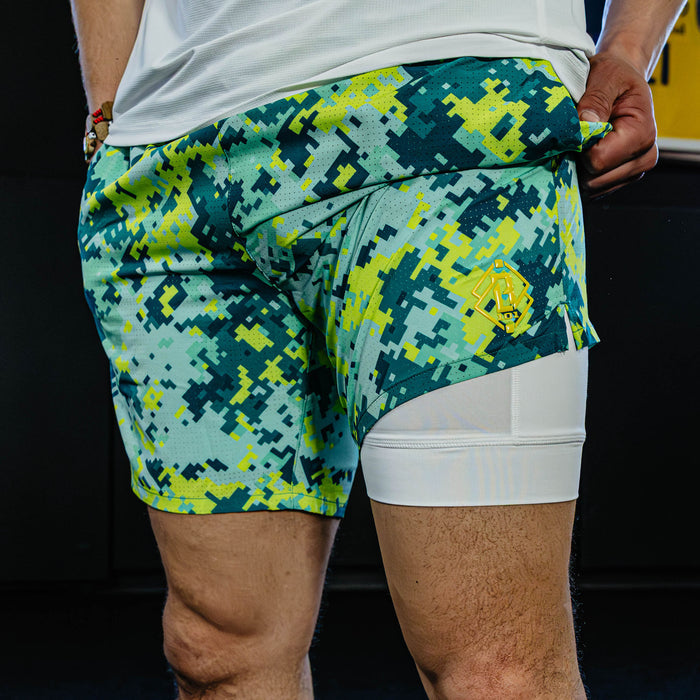 Person wearing green and blue camouflage shorts with white liner.