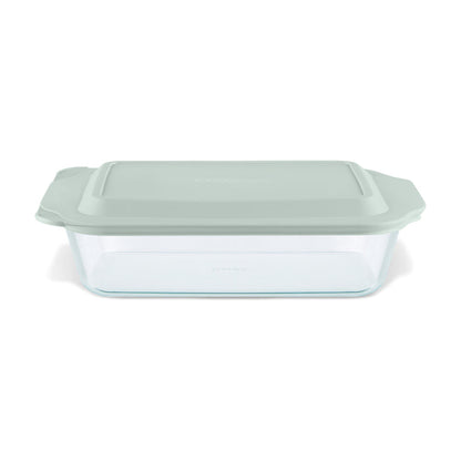 Glass baking dish with a green lid on a white background