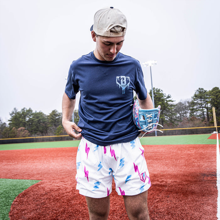 Adult model wearing white Rain Delay Lightning Bolt shorts
